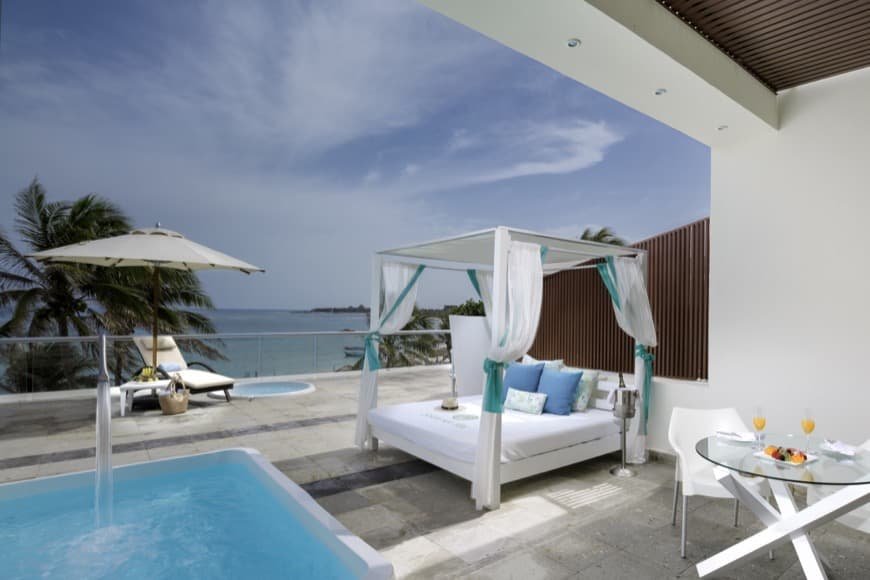 Master Suite lounge with armchairs, table, chairs and mini bar at The Sian Ka'an at Grand Tulum hote