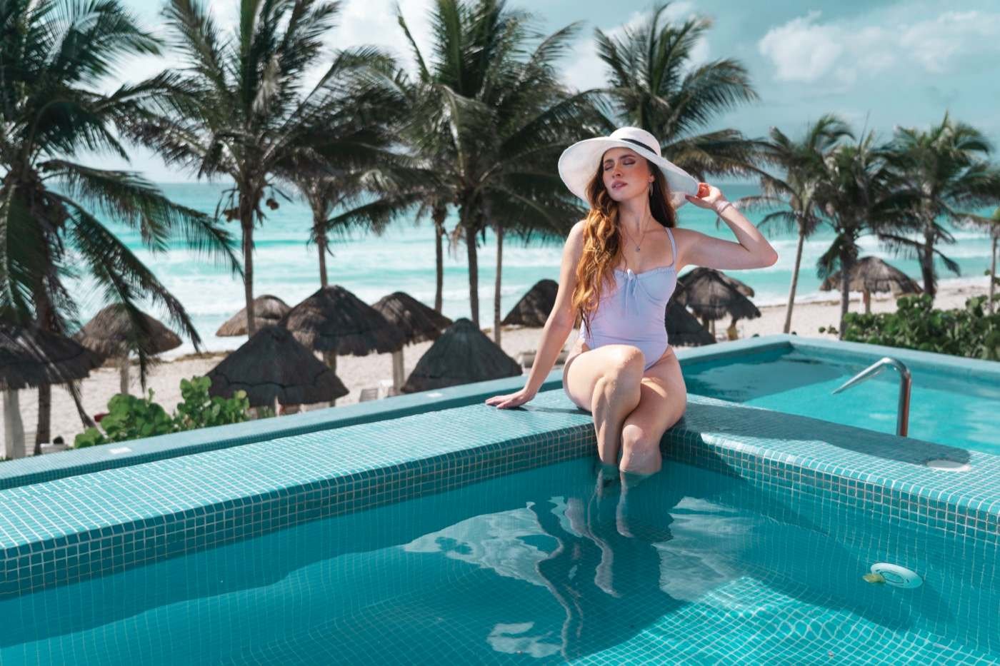 Woman enjoying the swimming pool at The Pyramid at Grand Oasis hotel