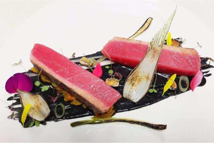 Smoked beef fillet with charred onion petals, foie gras sauce, kale soil, creamy smoke and saffron,